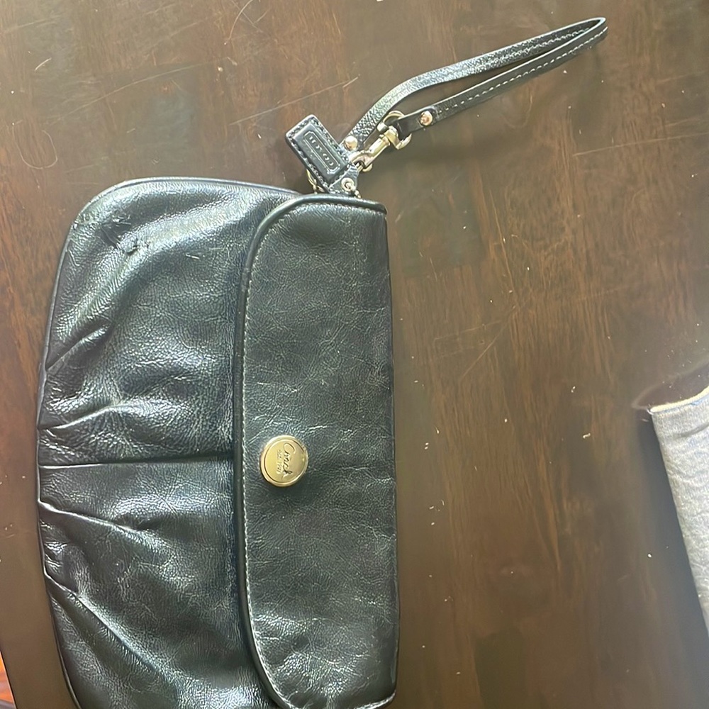 Vintage coach wristlet… immaculate and  clean interior, slight flaw shown
